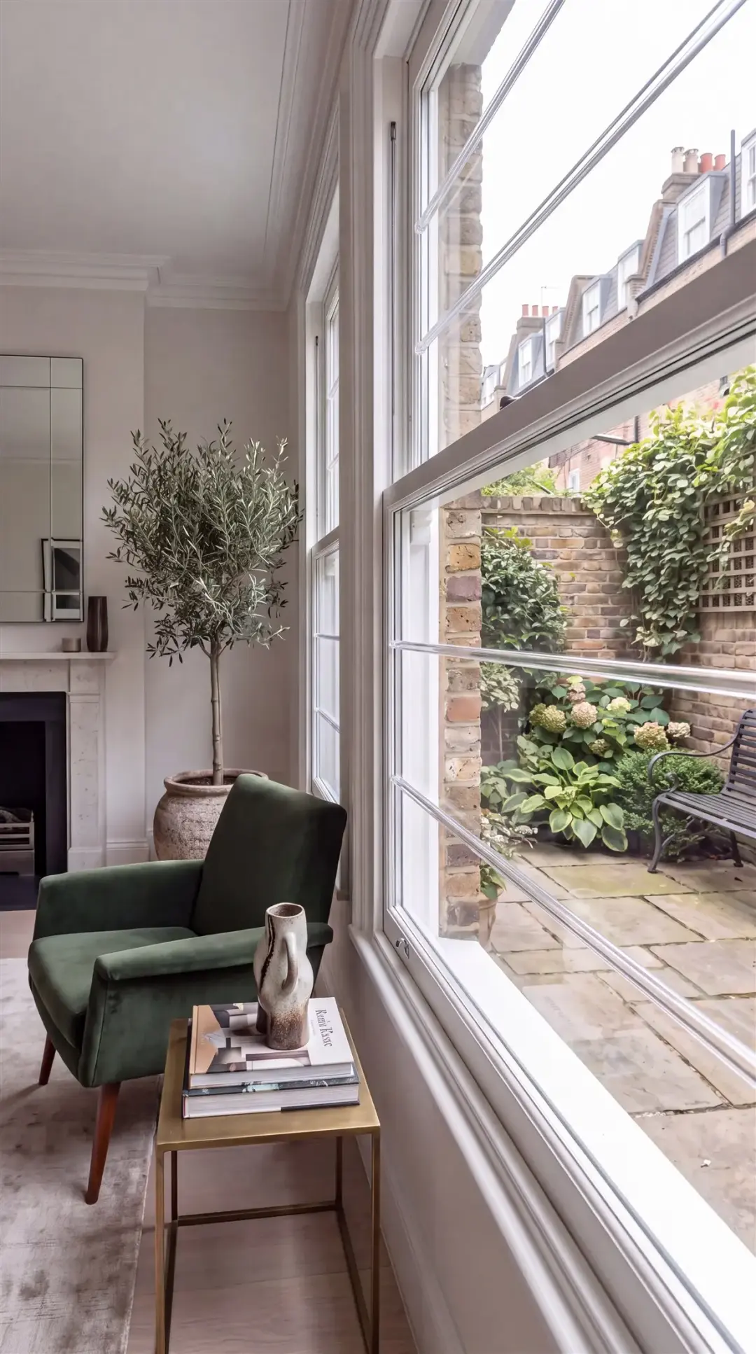 Transparent security bars fitted across a tall living-room window overlooking a garden